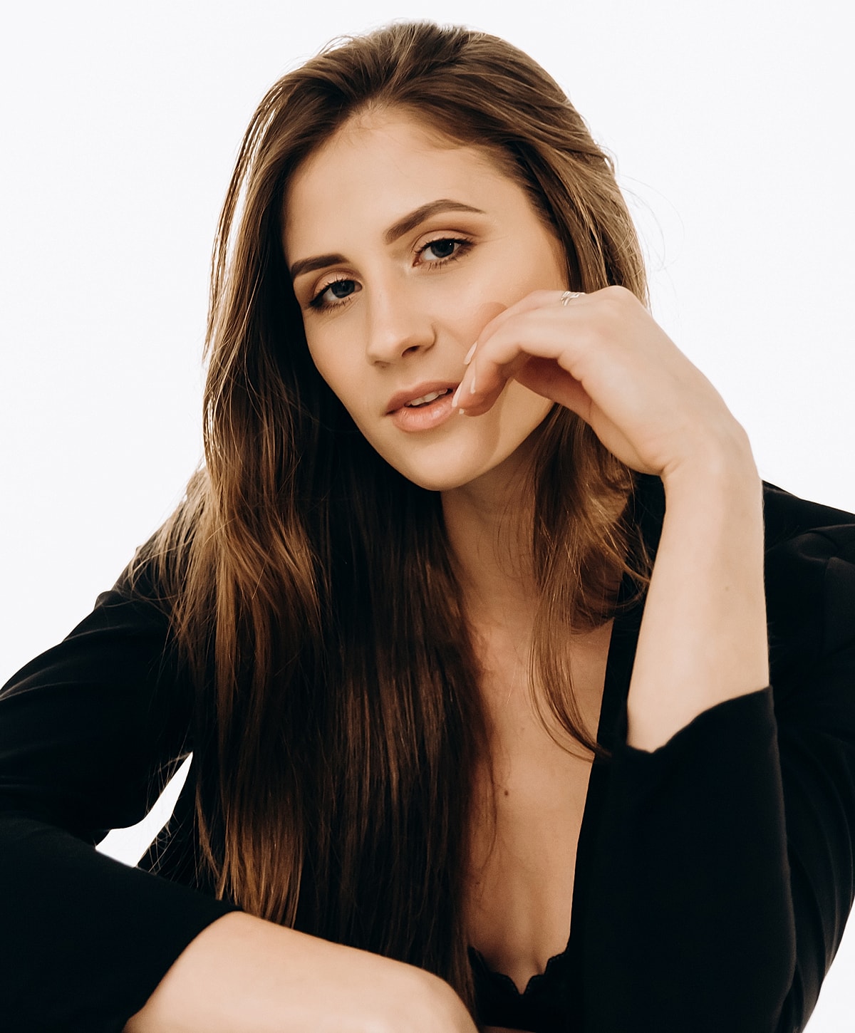 Woman with long hair, thoughtful expression.