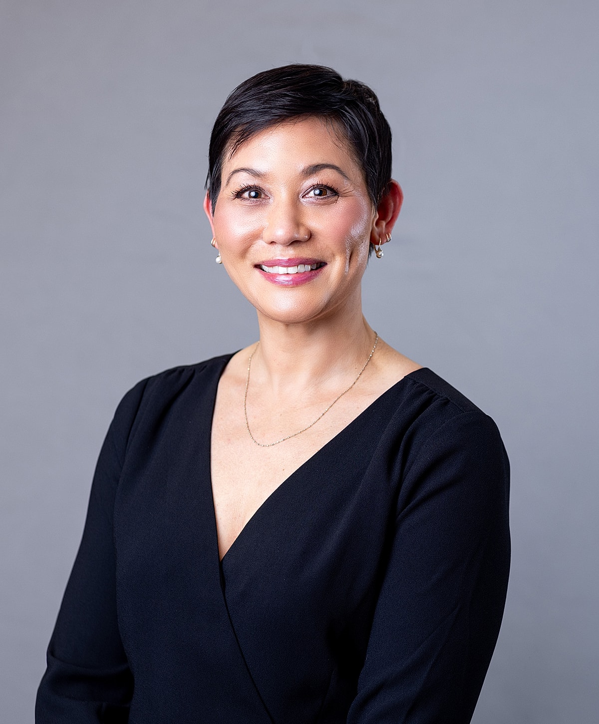 Professional headshot of a smiling woman.