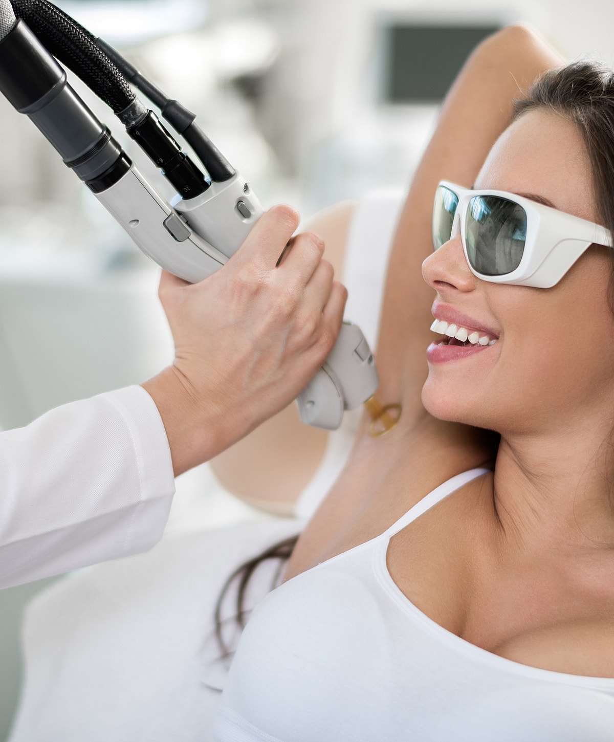 Laser hair removal treatment on woman's underarm.