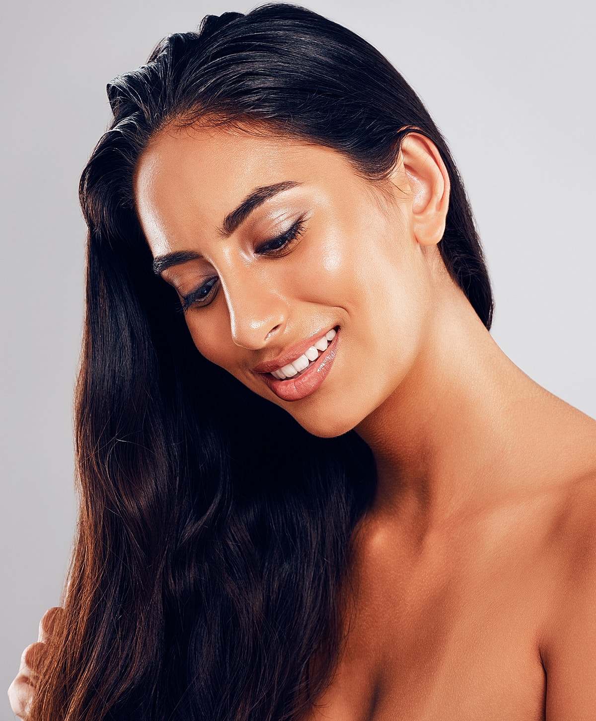 Smiling woman with long, dark hair.