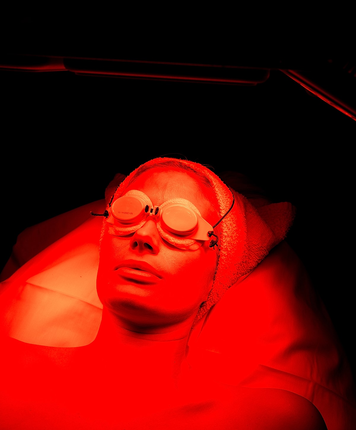 Person undergoing red light therapy treatment.