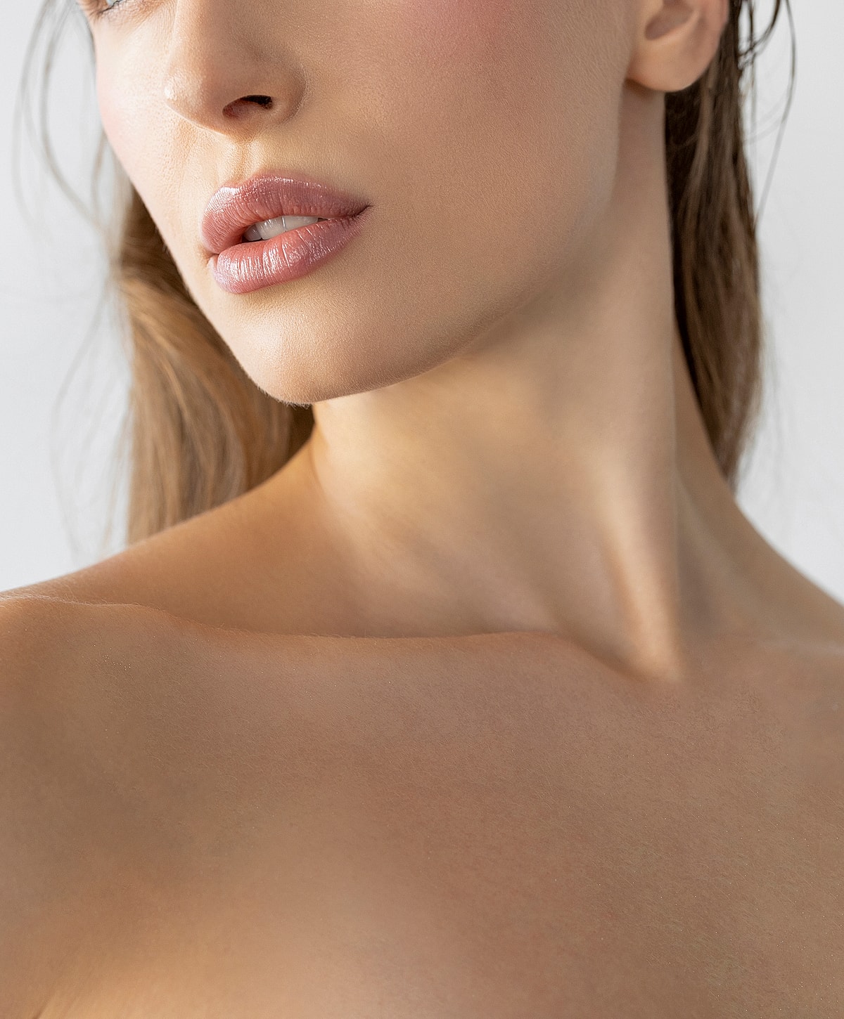 Close-up of woman's lips and shoulder.