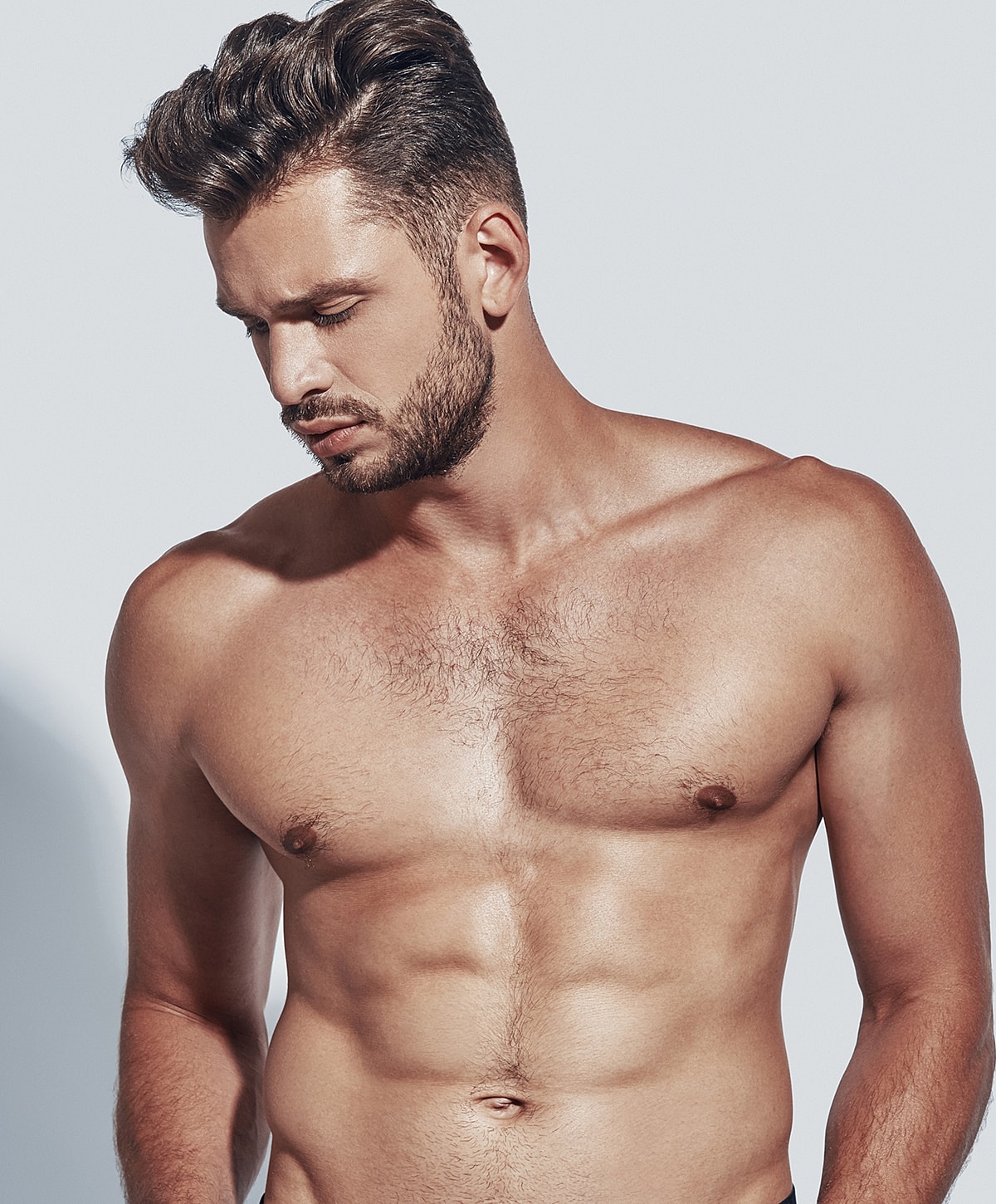 Shirtless man with a focused expression.