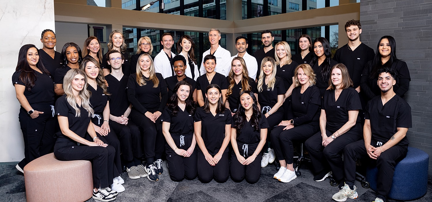 Team of healthcare professionals in black scrubs.