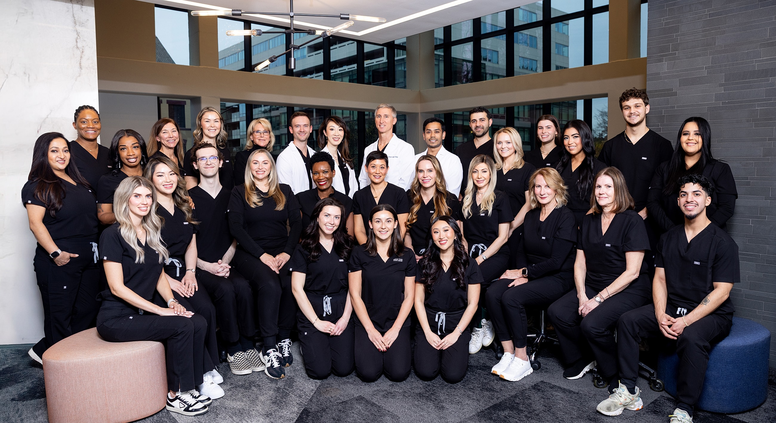 Medical team posing together in a modern office.