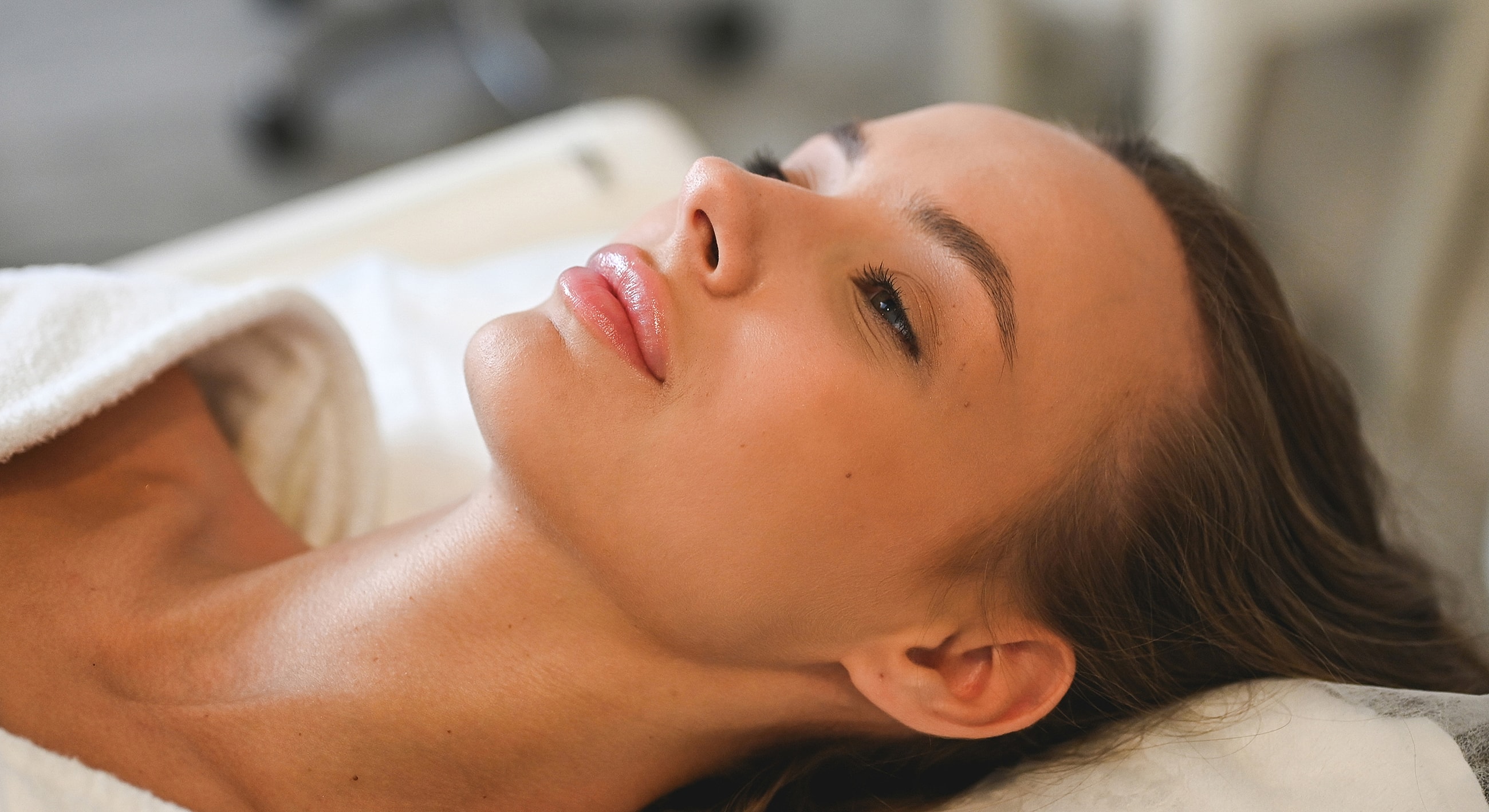 Relaxed woman receiving a facial treatment.