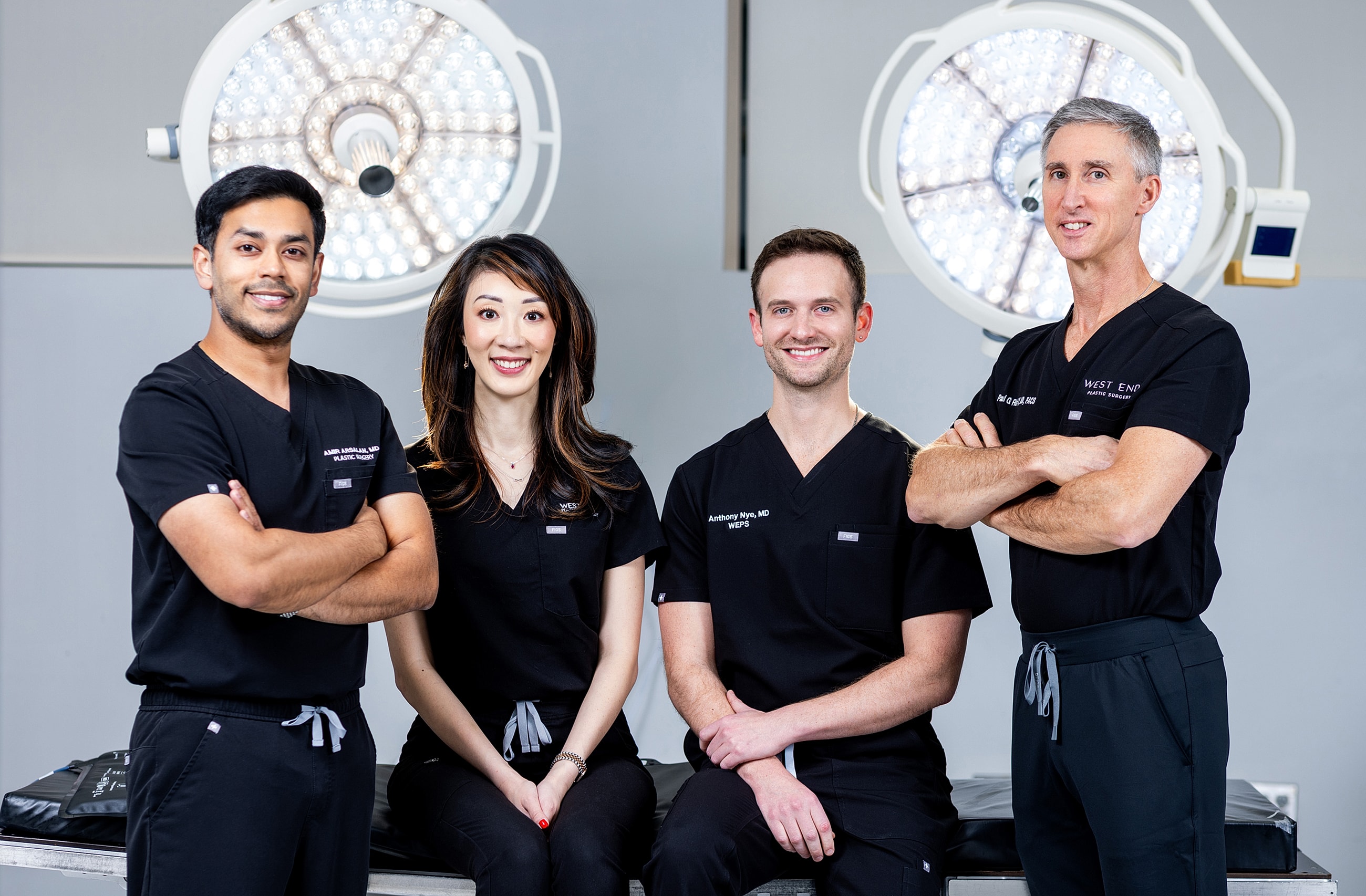 Medical team in surgical scrubs, smiling.