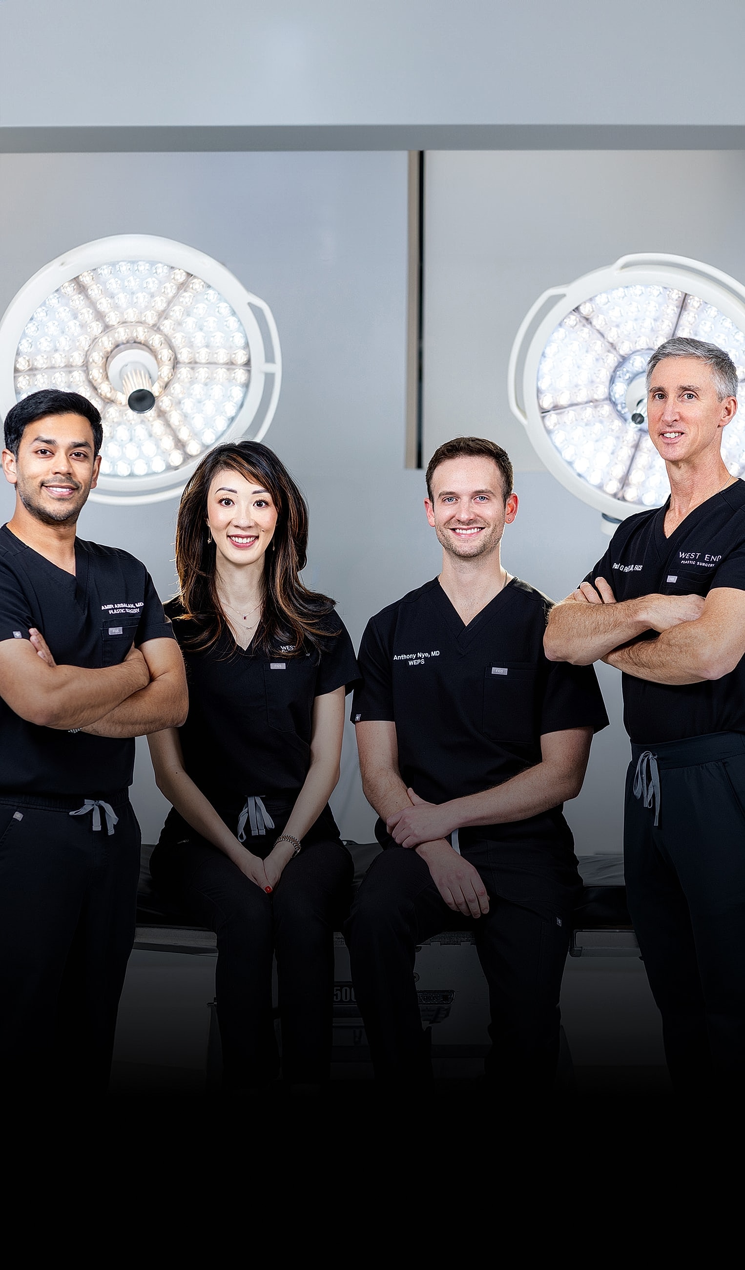 Medical team in surgical attire posing together.