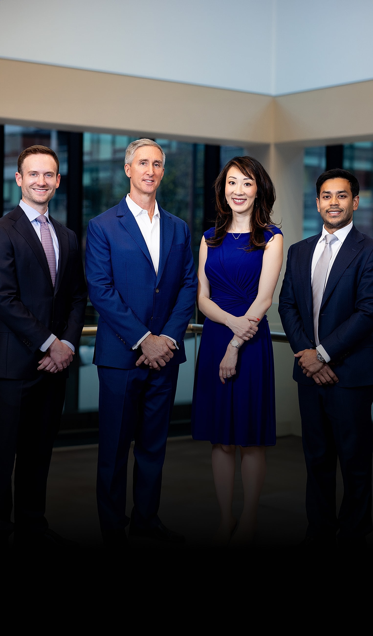 Group of professionals posing indoors.