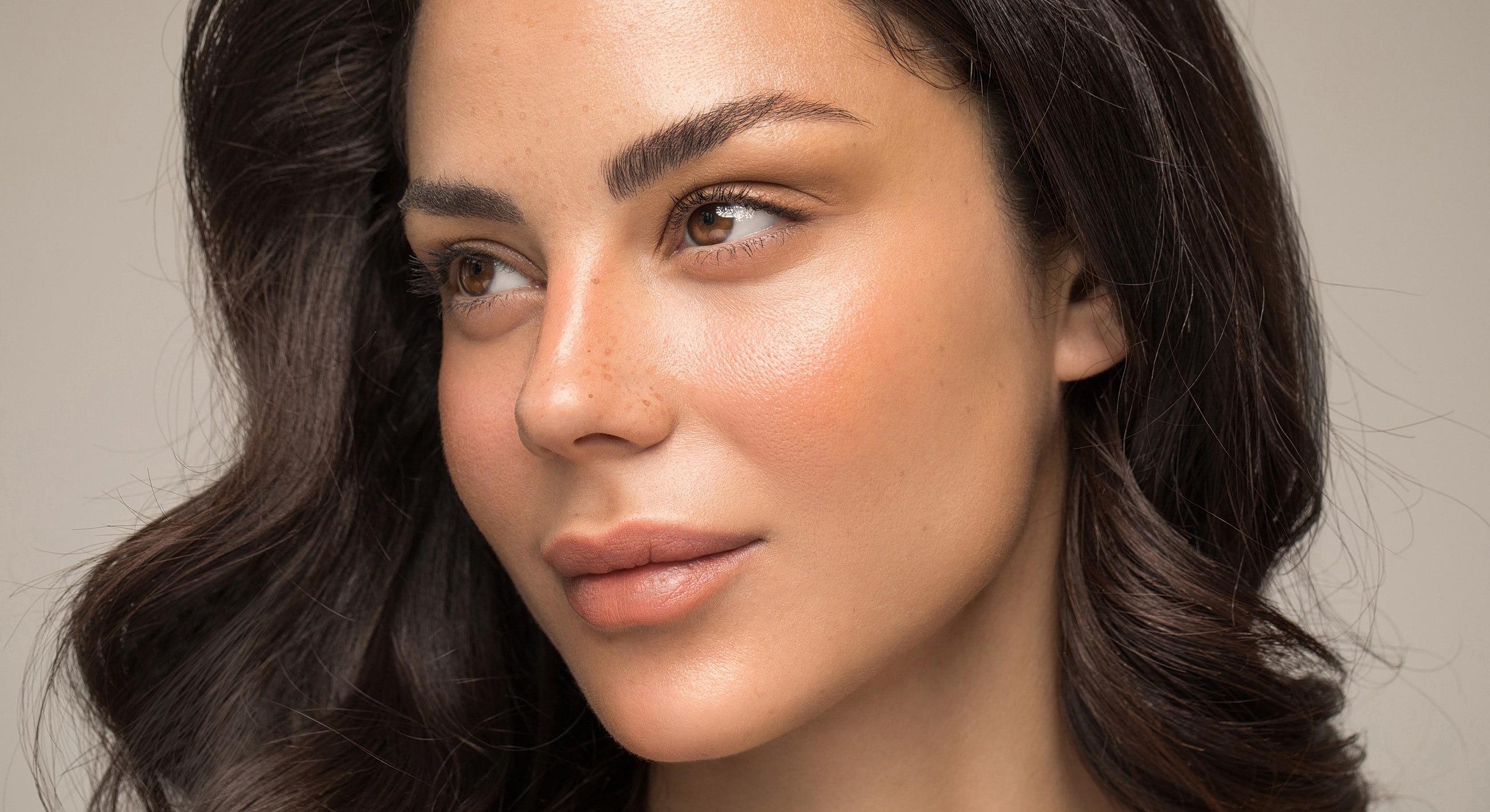 Close-up portrait of a woman with radiant skin.