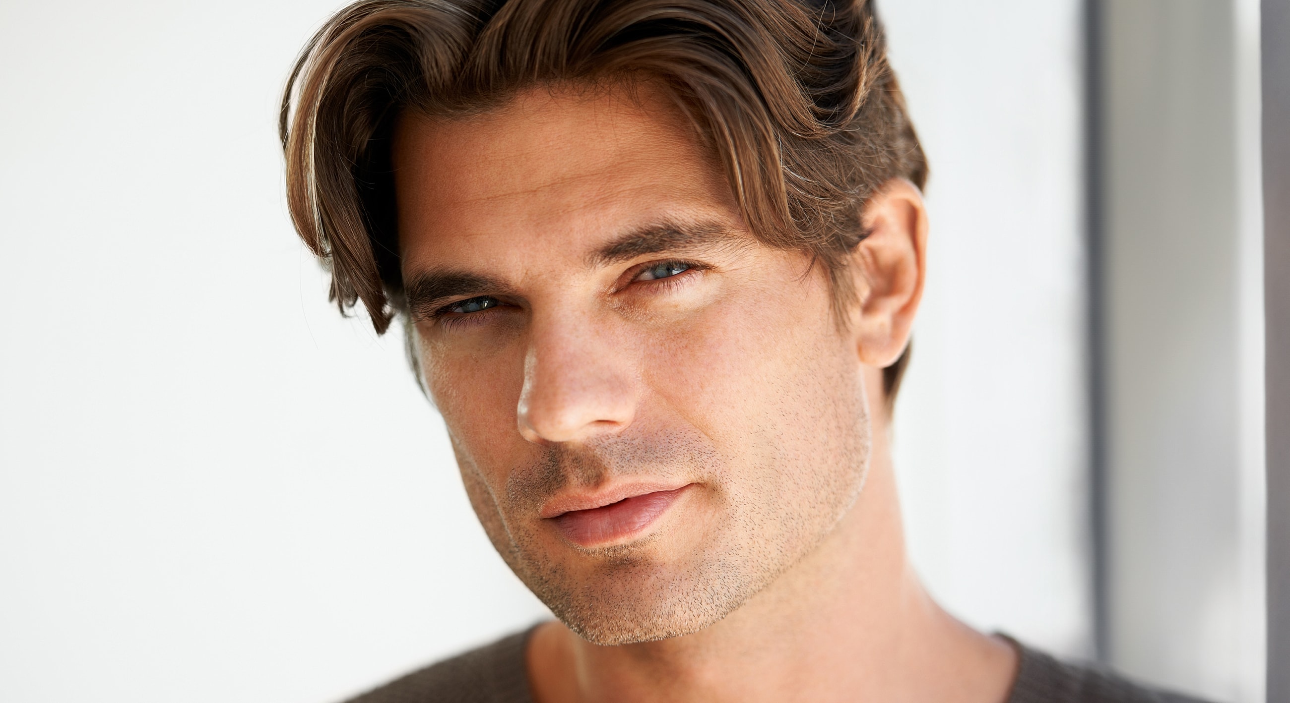 Man with tousled hair and engaging expression.